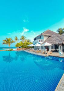 a swimming pool in front of a resort at Amaya Kuda Rah in Dhangethi