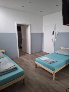 a room with two beds and an open door at Kapitän-Dallmann-Str in Bremen