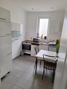 a kitchen with a table and chairs and a sink at Kapitän-Dallmann-Str in Bremen