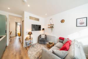 a living room with a couch and a tv at Grange8 Luxury Snug & Courtyard in Blairgowrie in Blairgowrie