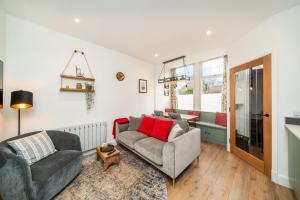 a living room with two chairs and a couch at Grange8 Luxury Snug & Courtyard in Blairgowrie in Blairgowrie