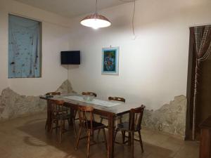 a dining room with a table and chairs at Tenuta Nonno Carmine in Porto Cesareo
