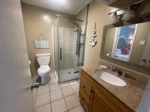 a bathroom with a toilet and a sink and a shower at Paradise PRN in Gulf Shores