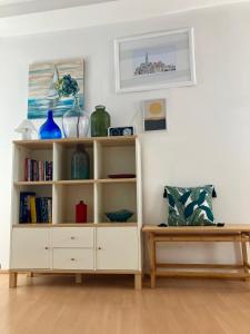 a white book shelf in a living room at Casa Plava sea view apartment in Rovinj
