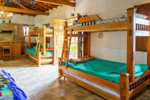 a room with three bunk beds in a house at CIUDADELA EL ARTESANO in Carolina del Principe