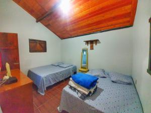 Postel nebo postele na pokoji v ubytování Chalé e Camping Elementais
