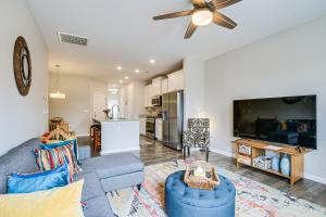 a living room with a couch and a tv at Southeast Greenville Townhome about 7 Mi to Downtown! in Greenville