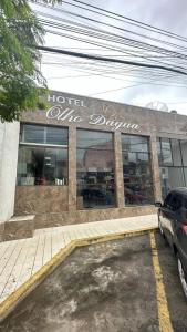 a store with a car parked in a parking lot at Hotel Olho D'água - Baturité in Baturité