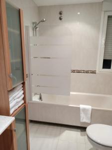 a bathroom with a shower and a tub and a sink at Casa Nano in Sigüeiro +28 photos