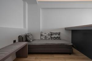 1 dormitorio con 1 cama junto a un piano en Adrina Grand Hotel, en Panormos Skopelos