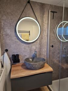 a bathroom with a bowl sink and a mirror at Ferienwohnung Ingrid in Kressbronn am Bodensee +26 photos