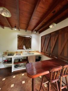 a kitchen with wooden cabinets and a wooden table at Villas Punta India in Playa Ostional