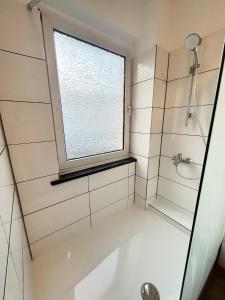 a bathroom with a shower and a window at Apartment Central 10H 75qm Wi-Fi free Parking in Dortmund