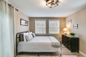 a bedroom with a bed and two windows at Ridgefield Cottage Walk to Town and Movie Theater! in Ridgefield