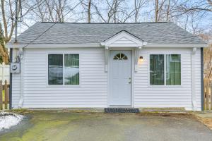 a small white house with a white door at Ridgefield Cottage Walk to Town and Movie Theater! in Ridgefield