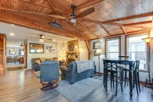 a living room with a ceiling fan and a table at Cozy Clear Lake Home - Walk to Town and Boat Dock! in Clear Lake