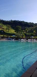 a large pool of blue water in a resort at hotel fazenda encanto in Guararema