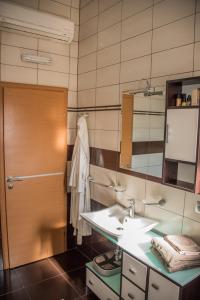 a bathroom with a sink and a mirror at Hotel Holy in Međugorje