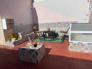 a patio with a table and chairs in a room at عقار الشرق الداخلة in Dakhla