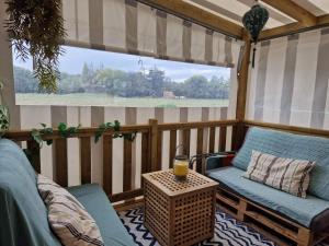 a screened in porch with a couch and a table at Mobil Home tout confort in Saint-Hilaire-de-Riez