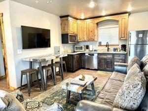 a living room with a couch and a kitchen at Angel Rock Rentals of Moab Unit 4 in Moab