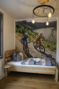 two people riding bikes on a bed in a bedroom at Conny's Träumerei in Bad Lobenstein