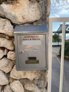 a box on the side of a stone wall at Apartments Nina & Paula - Apartment Nina in Štikovica