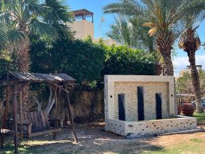 a monument in a park with palm trees and a building at Spacious apartments with Sea view at Samarah Resort in Sowayma