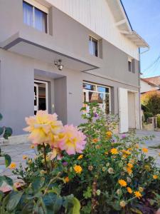 a house with flowers in front of it at Hosteria Puyehue in San Carlos de Bariloche