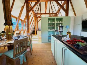 a kitchen with wooden beams and a table with tomatoes on the counter at TURM KAPS Luxury home direkt am Golfplatz by Belle Stay in Kitzbühel +56 photos
