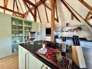 a kitchen with a counter with fruits and vegetables on it at TURM KAPS Luxury home direkt am Golfplatz by Belle Stay in Kitzbühel