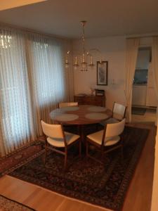 einen Esstisch mit weißen Stühlen und einem Kronleuchter in der Unterkunft My vintage Home in Solingen