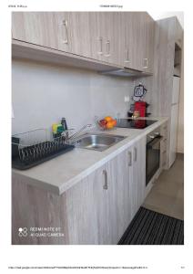 a kitchen with wooden cabinets and a sink at D&K Studio - Nafplio in Nafplio