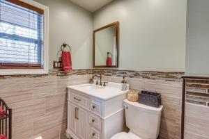a bathroom with a toilet and a sink and a mirror at Shirley Vacation Rental with Hot Tub, 7 Mi to Beach! in Shirley