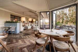 a restaurant with tables and chairs and windows at Craig Manor in Bowness-on-Windermere +123 photos