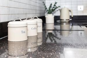 a counter with three white containers on a counter top at Everest Home in Nottingham