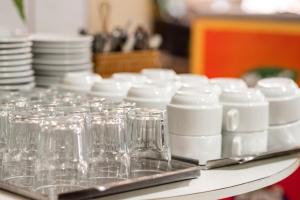 a group of wine glasses and plates on a table at HOTEL CENTRAL DE FORTALEZA in Fortaleza