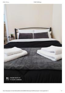 a bed with two white towels on top of it at D&K Studio - Nafplio in Nafplio