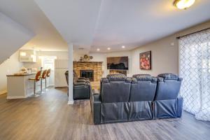 a living room with leather chairs and a kitchen at Pet-Friendly Woodbridge Retreat Near Potomac Mills in Woodbridge
