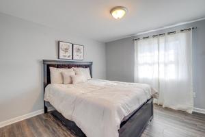a bedroom with a large bed with a window at Pet-Friendly Woodbridge Retreat Near Potomac Mills in Woodbridge