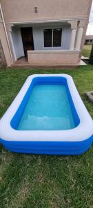 a blue and white pool in front of a house at Casa Nadreya Furnished Home Nakuru in Nakuru