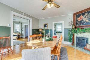 a living room with a wooden table and a fireplace at Dog-Friendly Green Bay Home, 1 Mi to Downtown! in Green Bay