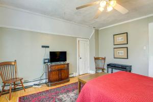 a bedroom with a bed and a flat screen tv at Dog-Friendly Green Bay Home, 1 Mi to Downtown! in Green Bay