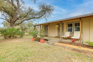 a small house with two chairs and a porch at Cozy Morriston Home Near World Equestrian Center! in Morriston