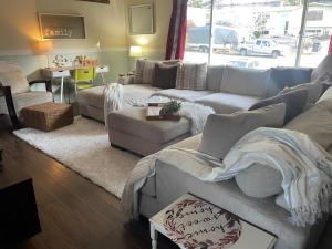 a living room with a couch and a table at Zen Queen Room in West Kelowna