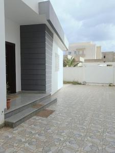 ein Gebäude mit einer schwarz-weißen Wand und einer Terrasse in der Unterkunft Amazing villa next to the beach in Nabeul
