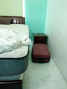 um quarto com uma cama e uma mesa de cabeceira ao lado de uma cama com uma cama em HOME OF KINGS AND QUEENS em Porto-Novo