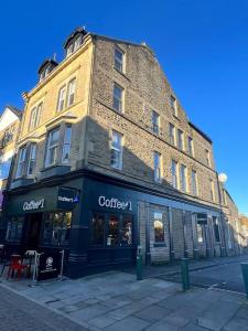 a large brick building on a city street at Central Buxton apt in Spring Gardens in Buxton