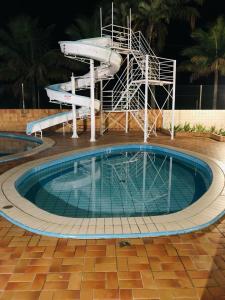 a large swimming pool with a slide in it at Apartamento Aconchegante - Boraceia (Bertioga) in Bertioga