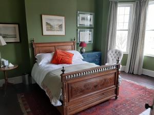 a bedroom with a bed with a red pillow on it at Trent Rd in London